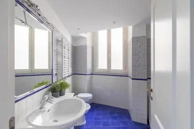 a bathroom with a white sink and a toilet at Colosseum Perfect Apartment in Rome