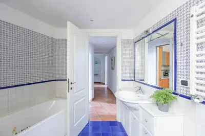a bathroom with a tub and a sink and a mirror at Colosseum Perfect Apartment in Rome
