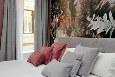 a bedroom with a bed with pillows and a painting at YCH-Butterfly Flat close Trevi Fountain in Rome