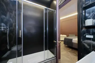 a glass shower door in a room with a bedroom at YCH-Butterfly Flat close Trevi Fountain in Rome