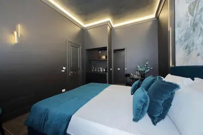 a bedroom with a large white bed with blue pillows at YCH-Butterfly Flat close Trevi Fountain in Rome