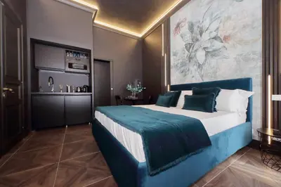 a bedroom with a large bed with a large painting on the wall at YCH-Butterfly Flat close Trevi Fountain in Rome
