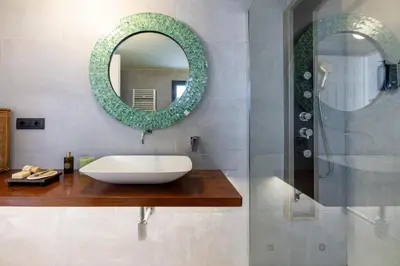 a bathroom with a sink and a mirror at ARIA Penthouse & Garden in Rome