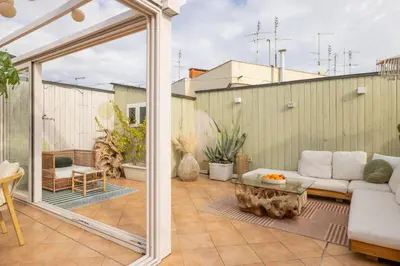 an outdoor patio with a couch and a table at ARIA Penthouse & Garden in Rome