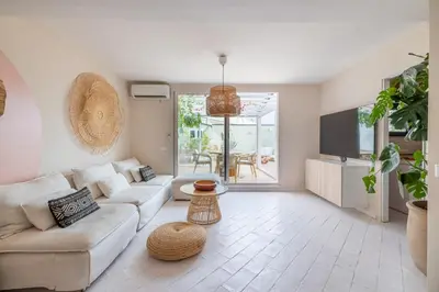 a living room with a couch and a table at ARIA Penthouse & Garden in Rome