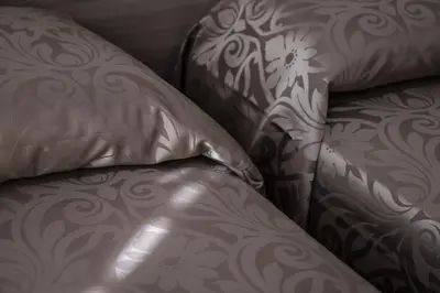 a brown leather couch with a pillow on it at Hotel Orbis in Rome