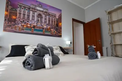 a bedroom with a bed with towels on it at Big Flat Rome Metro C in Rome