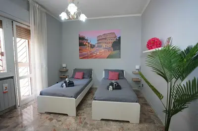 a room with two beds and a plant in it at Big Flat Rome Metro C in Rome