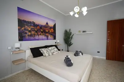 a bedroom with a bed with a large painting on the wall at Big Flat Rome Metro C in Rome