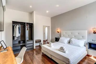 a bedroom with a large white bed and a tv at Effe Luxury Palace in Rome