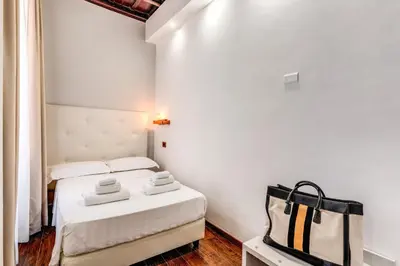 a small room with two beds and a bag at Effe Luxury Palace in Rome