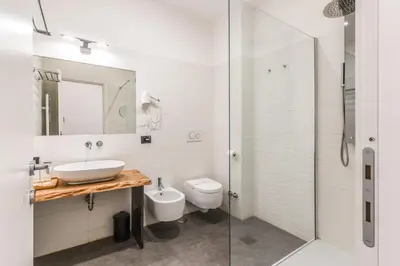 a bathroom with a sink and a toilet and a shower at Effe Luxury Palace in Rome