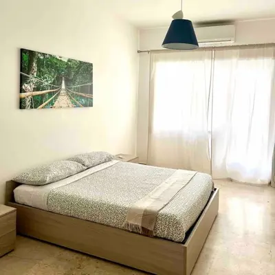 a bedroom with a bed and a large window at Glory house Vatican Museum in Rome