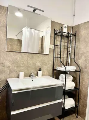 a bathroom with a sink and a mirror and towels at Glory house Vatican Museum in Rome