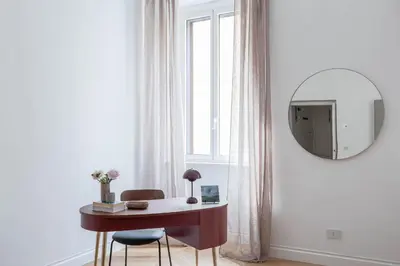 a room with a desk and a mirror and a window at iFlat Elegance and comfort in Monti in Rome