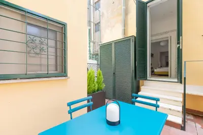 a blue table with a computer mouse on top of it at iFlat Elegance and comfort in Monti in Rome