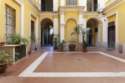 an empty courtyard of a building with potted plants at GM house Rome in Rome