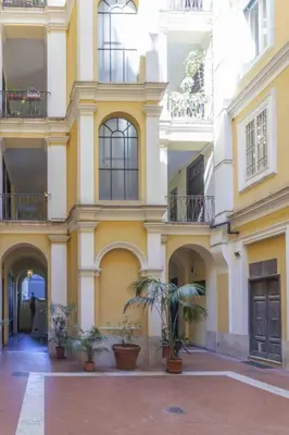 a building with potted plants in a courtyard at GM house Rome in Rome