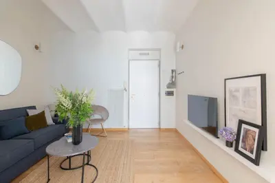 a living room with a blue couch and a table at iFlat Blue Cozy Loft near Saint Peter in Rome