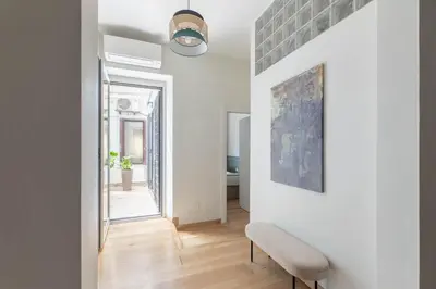 a living room with a bench and a painting on the wall at iFlat Blue Cozy Loft near Saint Peter in Rome