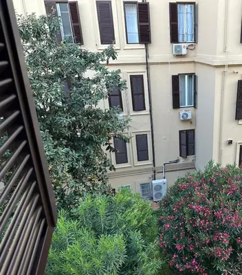 a view of a building with bushes and flowers at Rome Vatican City Whole Apartment 3 Private Rooms in Rome