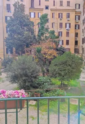 a view of a garden with trees and flowers on a balcony at Sui Generis Casa appartamento per vacanze in Rome