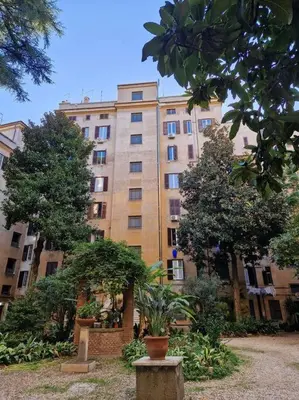 a large building with trees in front of it at Sui Generis Casa appartamento per vacanze in Rome
