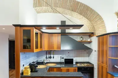 a kitchen with two sinks and a stove top oven at Trastevere - Viaggio a Roma Antica in Rome