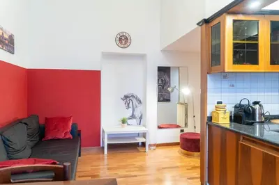 a kitchen and a living room with a couch at Trastevere - Viaggio a Roma Antica in Rome