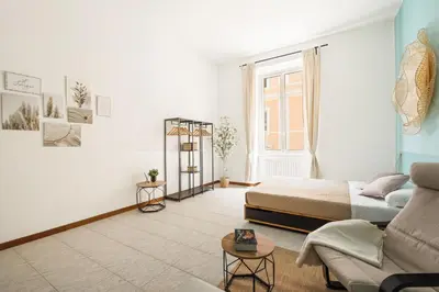 a living room with a bed and a couch at Imperial Nazionale in Rome