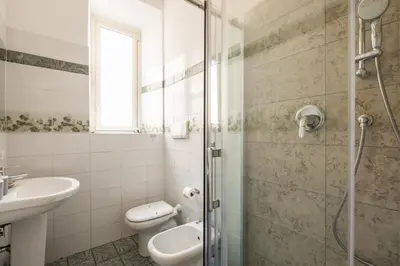a bathroom with a shower and a toilet and a sink at Imperial Nazionale in Rome