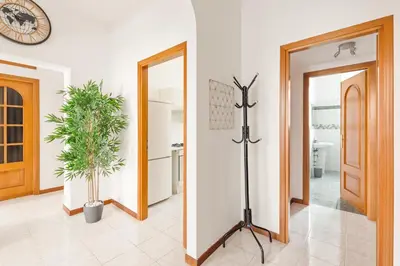 a hallway with a door and a clock on the wall at Imperial Nazionale in Rome
