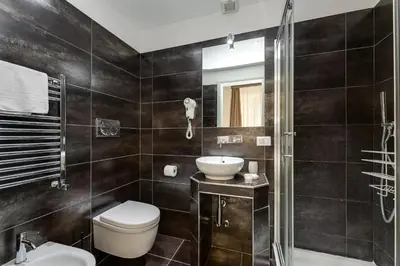 a bathroom with a toilet and a sink and a shower at Spagna Boutique Suites in Rome