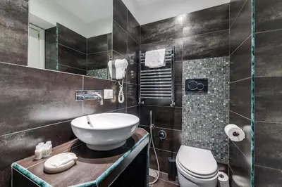 a bathroom with a sink and a toilet at Spagna Boutique Suites in Rome