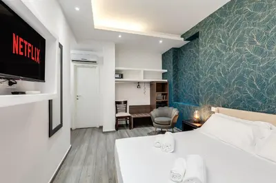 a hotel room with a bed and a tv at Spagna Boutique Suites in Rome