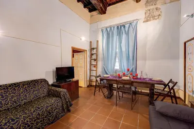 a living room with a table and a couch at Casa Savelli in Rome