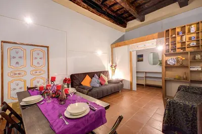 a living room with a table and a couch at Casa Savelli in Rome