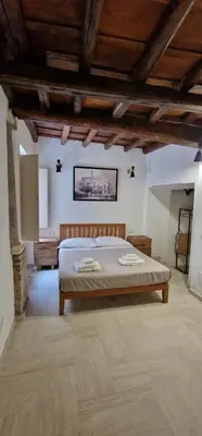 a bedroom with a bed and a wooden ceiling at Casina Giubbonari in Rome