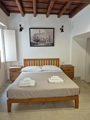 a bedroom with a bed with two towels on it at Casina Giubbonari in Rome