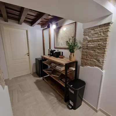 a room with a table and a brick wall at Casina Giubbonari in Rome