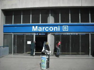 a woman standing in front of a marron b building at Guglielmo Marconi House in Rome