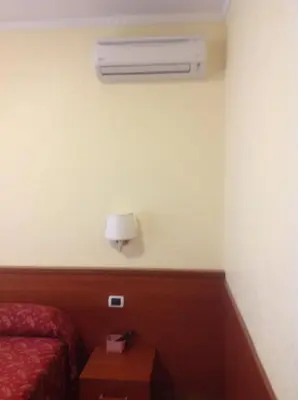 a hotel room with a bed and a air conditioner at Guglielmo Marconi House in Rome