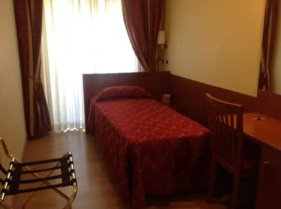a bedroom with a bed and a table and a window at Guglielmo Marconi House in Rome