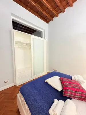 a bedroom with a large bed with a large window at DOMVS SPAGNA Via Gregoriana in Rome