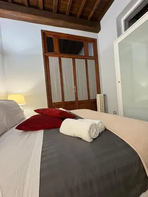 a bedroom with a bed with towels on it at DOMVS SPAGNA Via Gregoriana in Rome