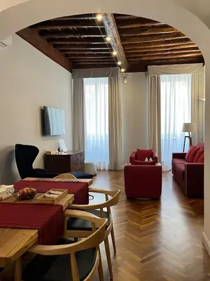 a living room with a couch and a table at DOMVS SPAGNA Via Gregoriana in Rome