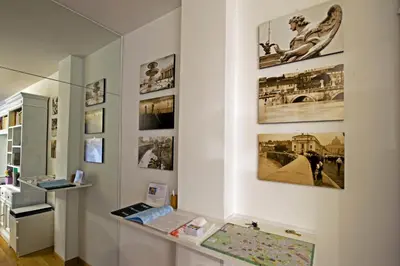 a display case in a museum with pictures on the wall at The Photos Room B&B in Rome