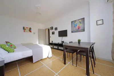 a bedroom with a bed and a desk and a table at The colours rooms guest house in Rome