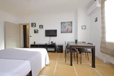 a bedroom with a bed and a table and a television at The colours rooms guest house in Rome