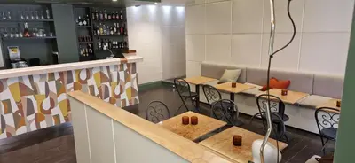 a restaurant with tables and chairs and a bar at Hotel Valerì in Rome